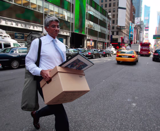 Image:  An employee of Lehman Brothers Holdings Inc. carries a box out of the company's headquarters