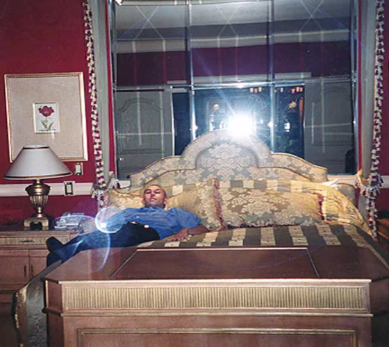 Robert Soloway lays on a bed in a Las Vegas hotel room during his days as a a high-flying spammer.