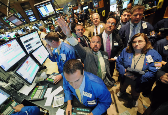Image: Traders work on the floor of the New York Stock Exchange