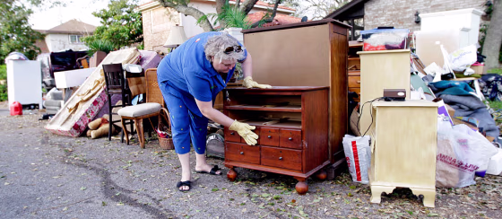 Image: Galveston resident going through damaged furniture