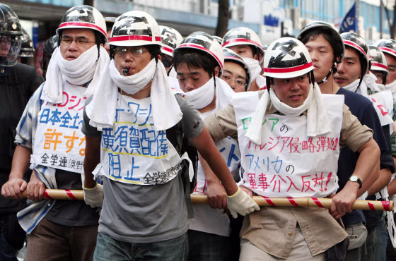Image: Protestors march against the deployment of USS George Washington
