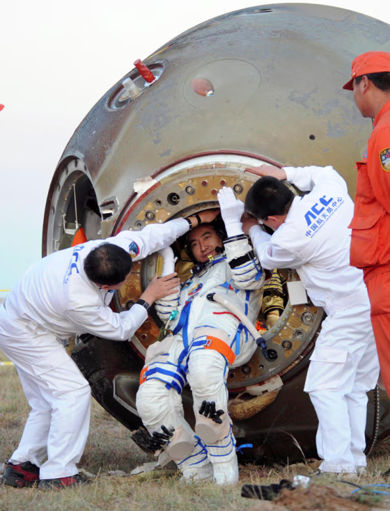 Image: Chinese taikonaut Zhai Zhigang is helped to get out of Shenzhou-7 re-entry module
