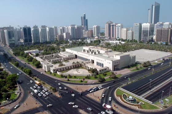 Image:  Cars drive on a busy highway intersection in downtown Abu Dhabi