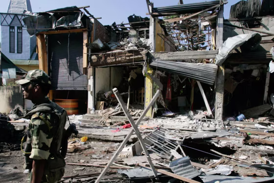 Image: A paramilitary soldier stands guard at the site of an explosion