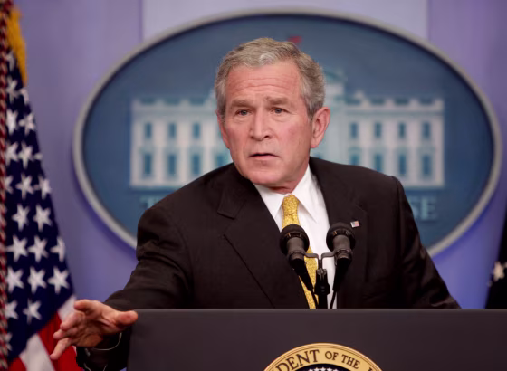 Image: George W. Bush gestures in the briefing room of the White House