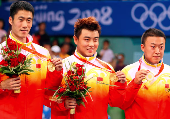Image: Chinese gold winners Wang Liqin, Wang Hao, and Ma Lin