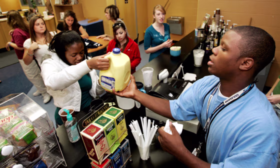 Image: Kwesi Utley, right, serves customers in the library coffeehouse at Centennial High School in Franklin, Tenn.