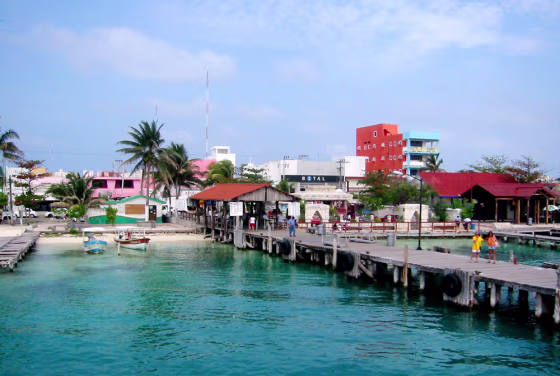 Isla Mujeres, a tiny island mere miles from the Yucatan coast, feels a world away from Cancun's garish hustle and bustle. Instead of the chain restaurants and mammoth resort hotels of neighboring Cancun, Isla Mujeres, though also thriving in its own tourism, manages to maintain the feeling of a small fishing village. 