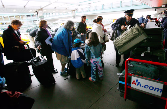 Image: Travelers wait to check in for flight at New York's LaGuardia Airport prior to Thanksgiving holiday