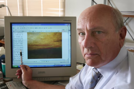 Image: Greek scientist Christos Zerefos shows one of the paintings that he studied