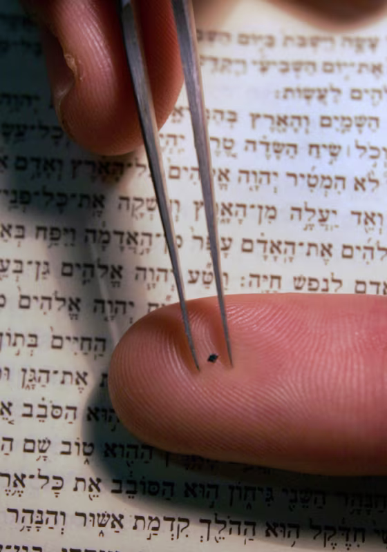 Image: Haifa's Technion University spokesman Ohad Zohar displays a chip containing the entire Hebrew Bible