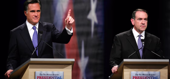 Image: Republican presidential hopefuls former Massachusetts Gov. Mitt Romney and former Arkansas Gov. Mike Huckabee during the Des Moines Register Republican Presidential Debate