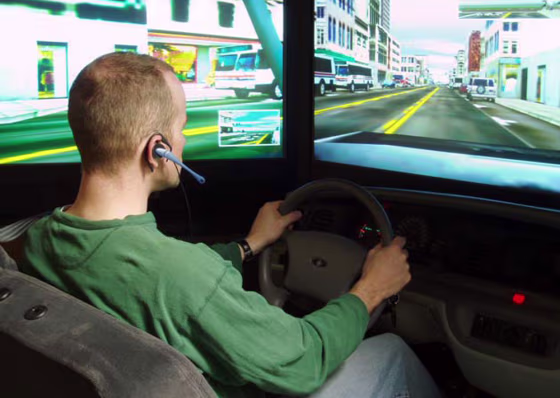 A student talks on a hands-free cell phone while operating a high-tech driving simulator during a University of Utah study in 2008. In addition to driving like impaired drunken drivers with blood-alcohol levels at the legal limit of 0.08 percent,&nbsp;the study showed chatty motorists bog down traffic. 