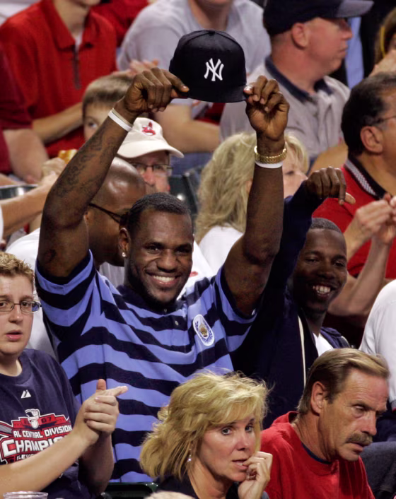 Image: LeBron James holds up his New York Yankees hat