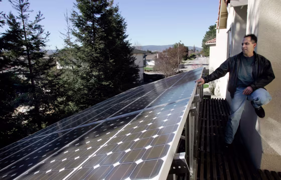 Image: Mark Vargas shows the solar panels on his home