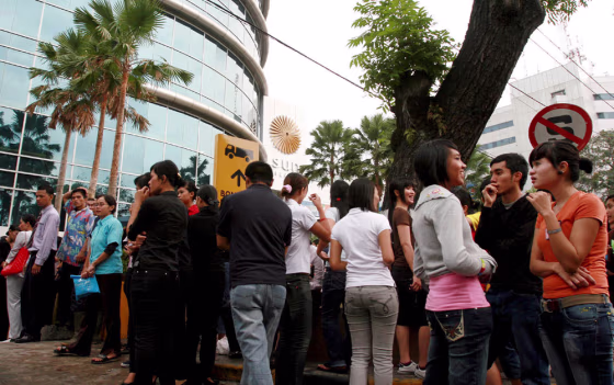 Image: Employees and mall goers evacuate to the open air for safety in Medan.