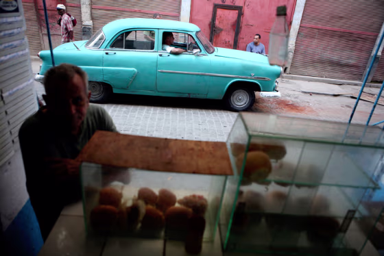 A customer waits to buy a hamburger in Havana, Cuba. Americans hoping Fidel Castro's resignation will bring new travel opportunities are in for a long wait, columnist Christopher Elliott writes.