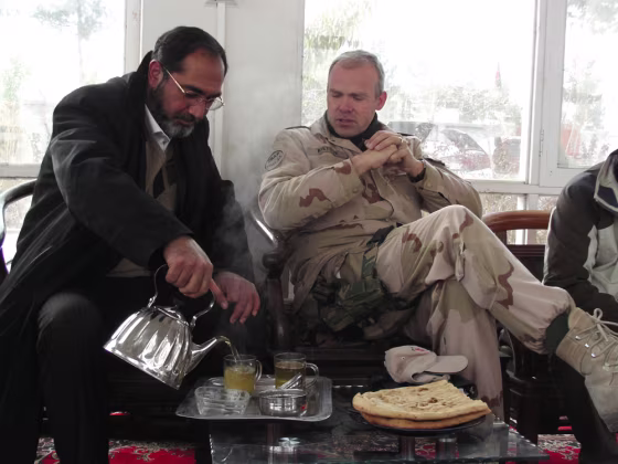 Image: Uruzgan Gov. Assadullah Hamdam pours tea for Dutch reconstruction team cheif, Lt. Col. Wilfred Rietdijk.