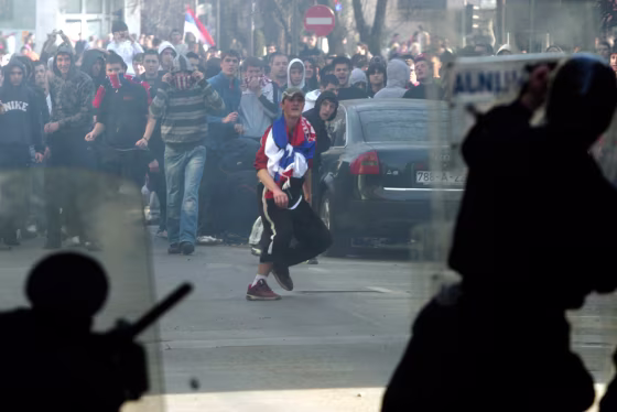 Image: Bosnian Serb policeman face off with protesters in Banja Luka.