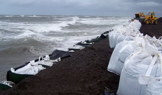 Image: Sandbags are stacked along the seawall in Kivalina, Alaska