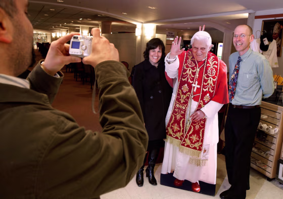 Image: tourists pose with Pope cutout
