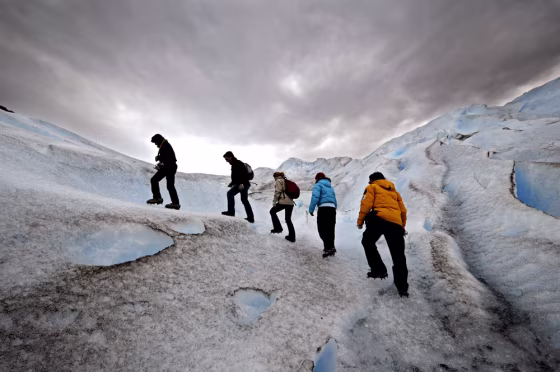 Image: Tourists follow mountain guide.