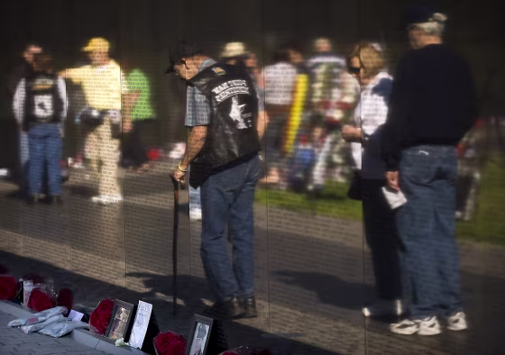 Image: Visitors file by the Wall, which currently contains 58,249 names of fallen soldiers