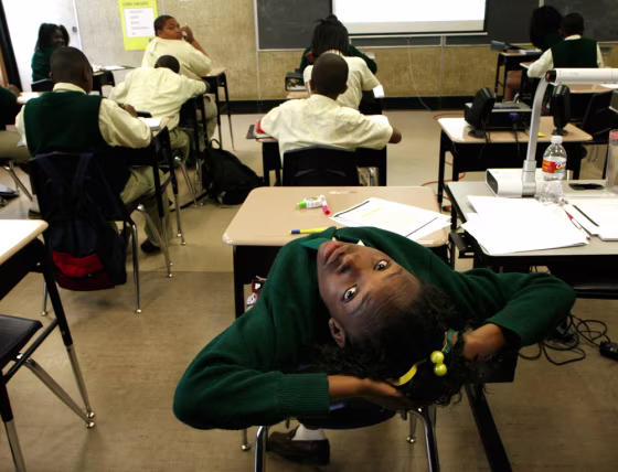 Claudreka Miller stretches during a language&nbsp;arts class at New Orleans College Prep charter school in New Orleans, La.,&nbsp;on May 5. Students at the school wear uniforms and have a longer school day. 