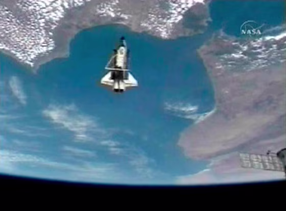 Image: Space Shuttle Discovery and Earth after undocking from ISS