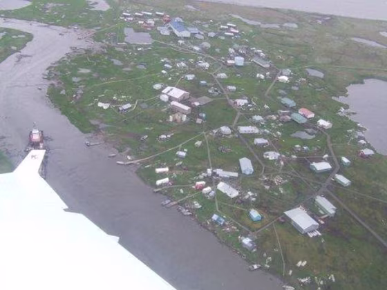 This aerial view of Newtok, Alaska, shows a town surrounded by water.