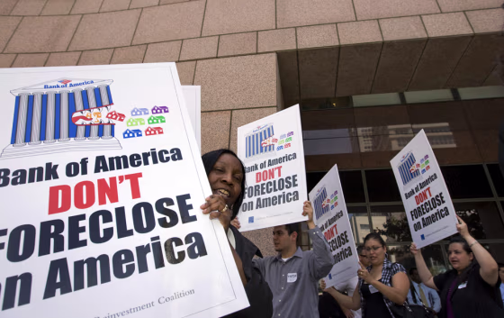Image: Demonstrators hold signs in front of the Federal Reserve Bank in Los Angeles