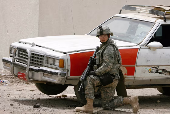 Image: U.S. soldier near car in Baghdad