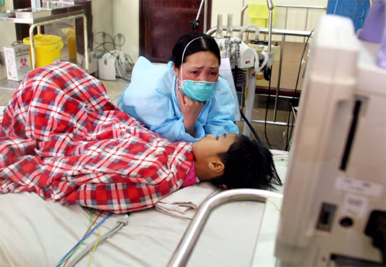 VIETNAMESE WOMAN TENDS TO HER SON WHO IS SUSPECTED OF HAVING BIRD FLU