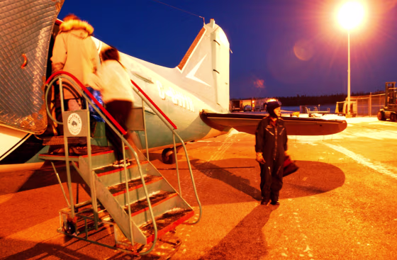 Copilot Kelsey Ball braves the cold while passengers board a daily Buffalo Airways DC-3 flight.