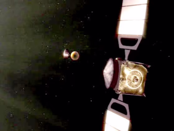 An artist's conception shows the Mars Express orbiter, at right, ejecting the Beagle 2 lander toward Mars, days in advance of the scheduled landing.