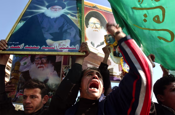 At&nbsp;a demonstration in Baghdad Tuesday,&nbsp;Shiite Muslims carrying flags and posters of&nbsp; clerical leader Mohammed Sadiq al-Sadr call for&nbsp;Saddam Hussein's execution. 