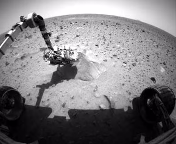 At the time this picture of Spirit probing its first target rock&nbsp;was snapped, the rover was analyzing&nbsp;it with its alpha particle X-ray spectrometer. The result of that analysis is stuck within the rover's memory.