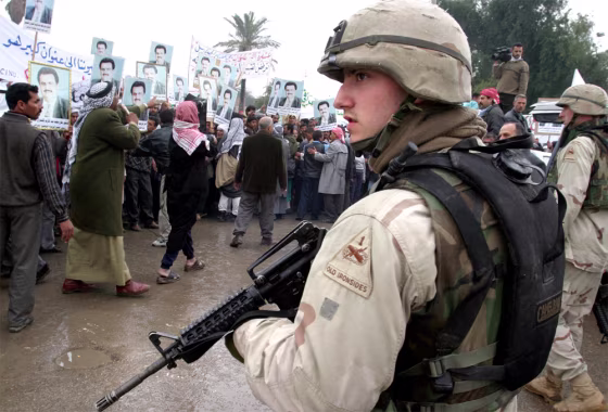 U.S. ARMY TROOPS WATCH PROTEST BY IRAQI GROUP AGAINST PLANNED FEDERAL SYSTEM