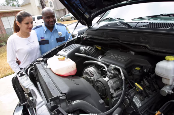 Carlton Jack, right, and his wife Lourdes look at the engine of one of their Hemi-equipped Dodge RAM 1500 pickups at their home in Spring, Texas last month. Jack was so enamored with his big-engine truck that bought one for his wife at Christmas.