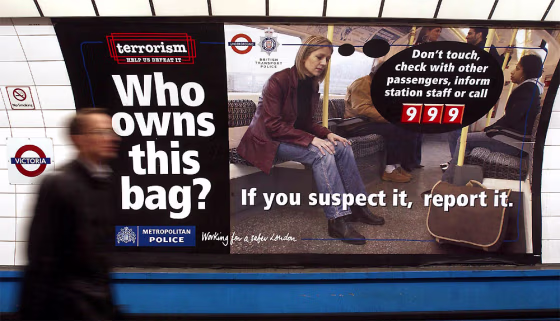 POSTER ASKING MEMBERS OF PUBLIC TO REPORT SUSPECT BAGS IS SEEN AT VICTORIA UNDERGROUND STATION LONDON