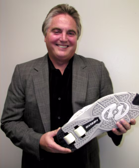 Roger Adams holding a Heelys shoe that was specially designed for Shaquille O'Neal — a size 22.