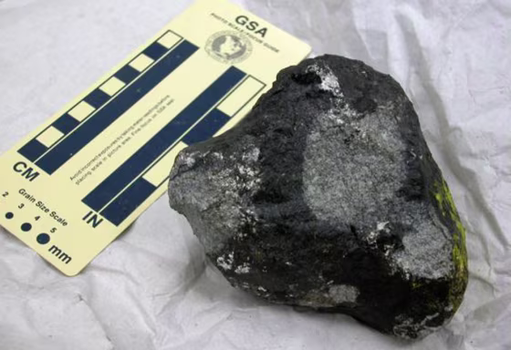 This&nbsp;Chicago-area meteorite fragment,&nbsp; collected in 2003, is shown with a scale of inches and centimeters for reference. It was embedded in the street. Note the yellow paint on the far right side, picked up on impact.
