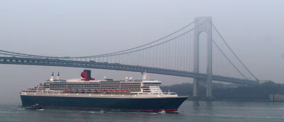 The Queen Mary 2 sails under the Verrazano Narrows bridge at low tide, six days after leaving England.
