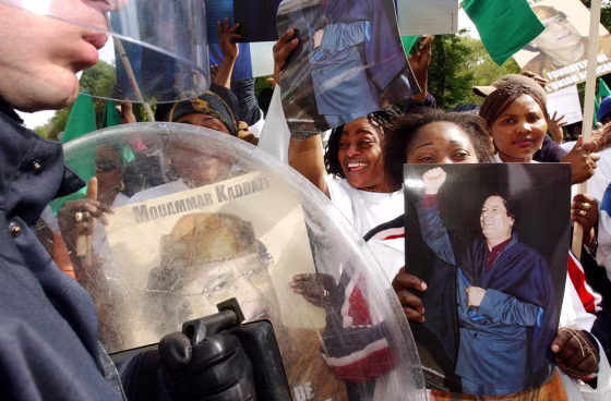 Supporters of Moammar Gadhafi&nbsp;show photos and posters of the Libyan leader&nbsp;outside European Union Commission headquarters in Brussels Tuesday. 