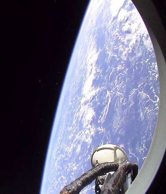 Earth and the blackness of space loom outside&nbsp;the window of a Soyuz space capsule in a picture taken by Dutch astronaut Andre Kuipers.