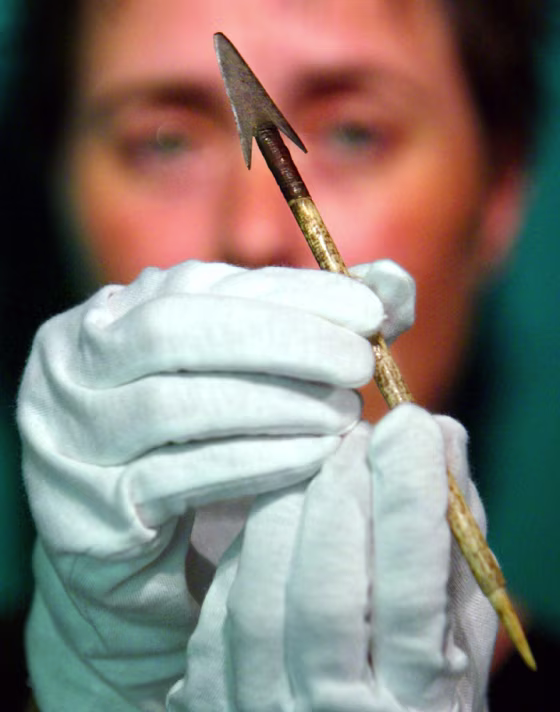 JUDE PHILP HOLDS AN ARROW HEAD WITH A BONE SHAFT IN SYDNEY