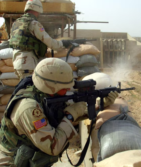 A U.S. soldier from the 2nd Armed Cavalry Regiment shoots an M-4 assault rifle at insurgents in Najaf on Monday.