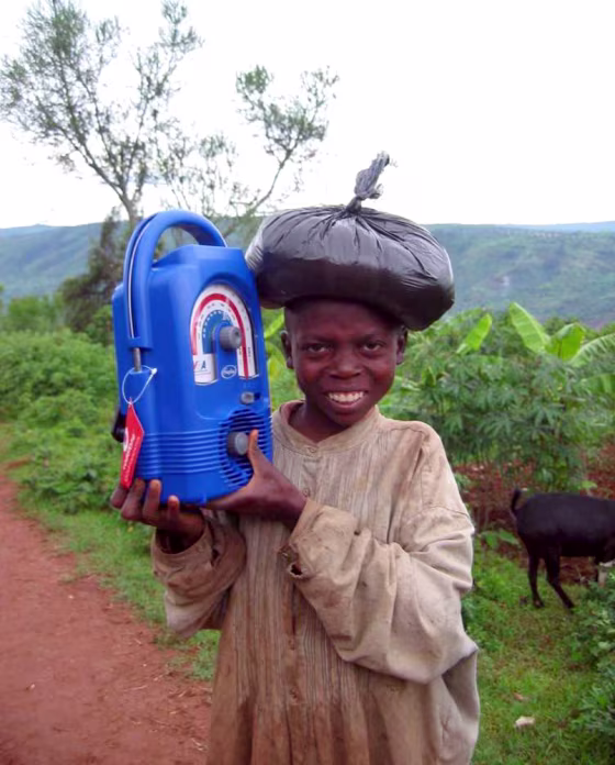A young boy listens to a Lifeline radio in Mugumbazi, Rwanda.