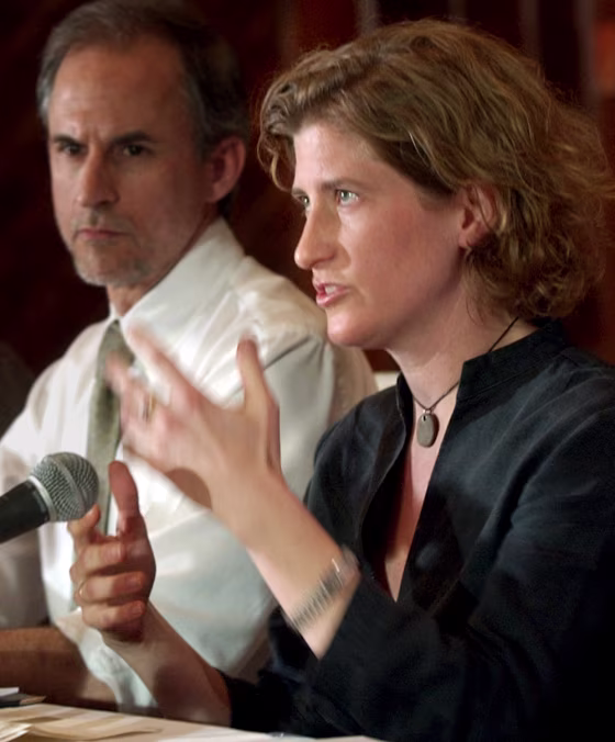 Freelance photographer Molly Bingham, sitting beside Newsday editor Jim Rupert, talks with reporters in Jordan after her release from Abu Ghraib on April 2, 2003. Bingham and Rupert were among the group of journalists being released from an Iraqi prison.