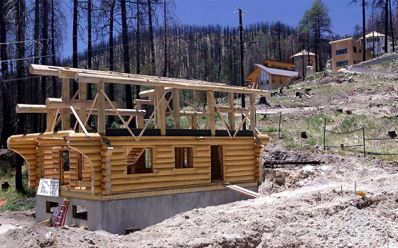 The Rainbow Gift Shop is being rebuilt along with homes on a hillside that the Aspen Fire destroyed in Summerhaven, Ariz., a year ago.